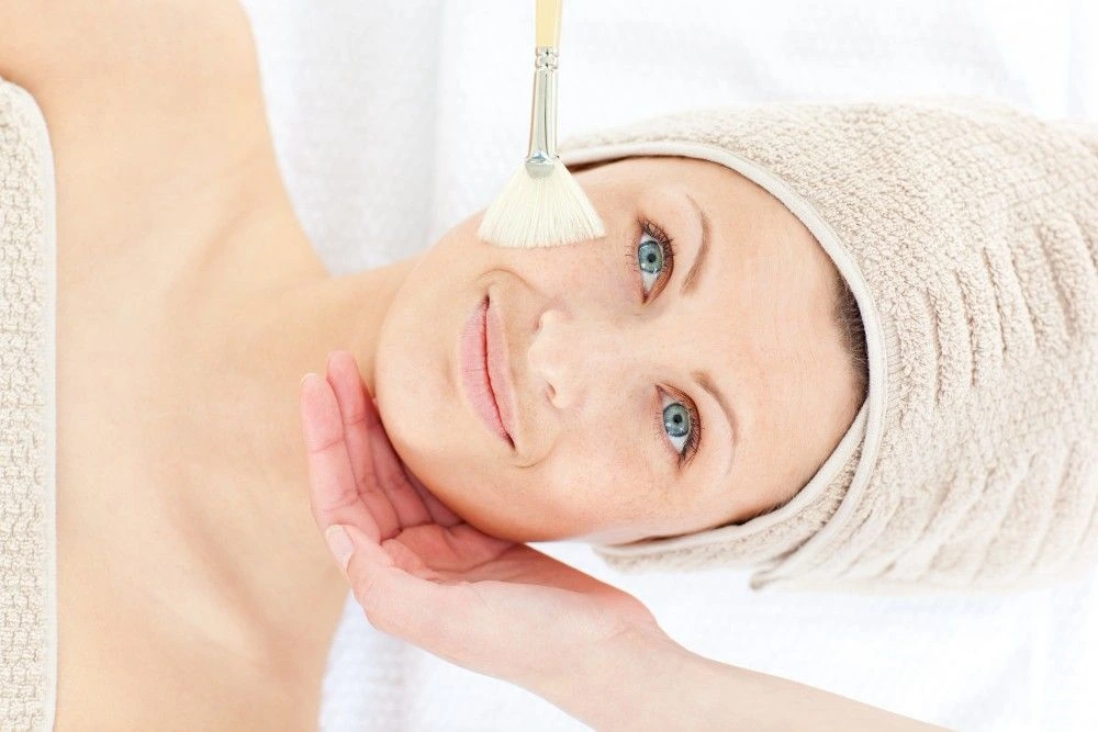 Woman with radiant skin after chemical peel for pimple marks